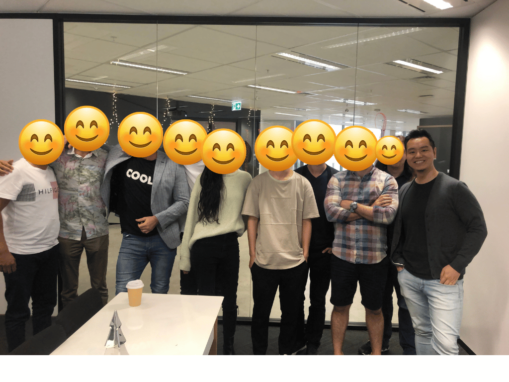 A group gathered in a meeting room, with smiling emoji overlays.