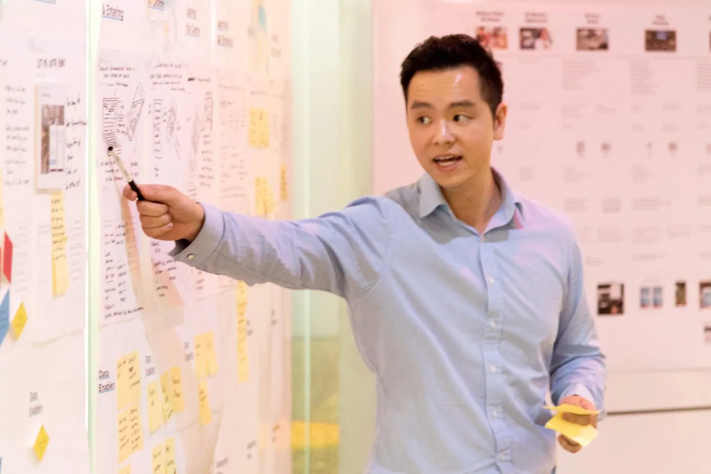 Dave walking a group through sticky notes on a workshop wall.